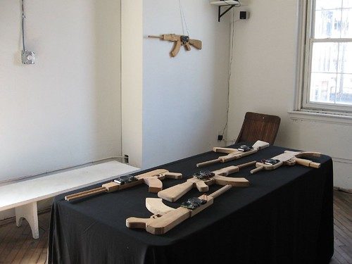Ricardo Miranda Zúñiga, Transmitting Ideology, 20 carved wooden guns equipped with radios.