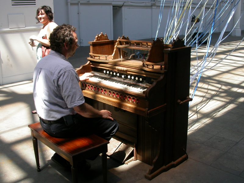 A passer by sits at David Byrne's piano in Playing the Building in New York, a Creative Time project.