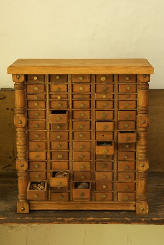 Found cabinet filled with specimens. Drawer pulls are nails.