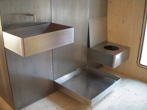 System3's no nonsense open-plan bathroom.