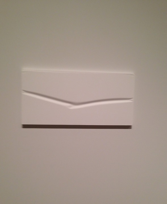 white sculpture on a white wall