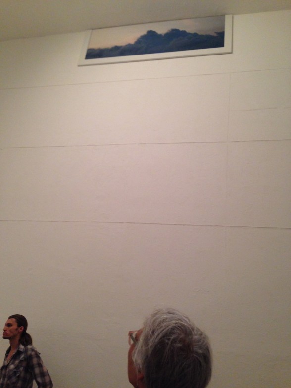 photograph very high on wall, woman looking up