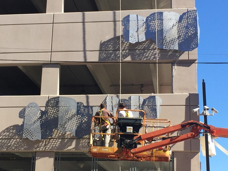 Workers installing Rebecca Rutstein's Sky Terrain public art piece at Temple University