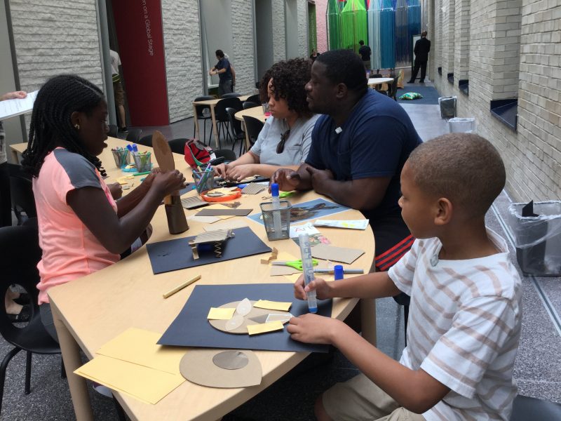 Art Splash, family making masks after seeing the African artifacts in Creative Africa