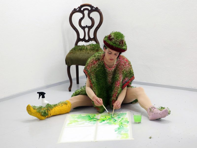 artist with plants and chair
