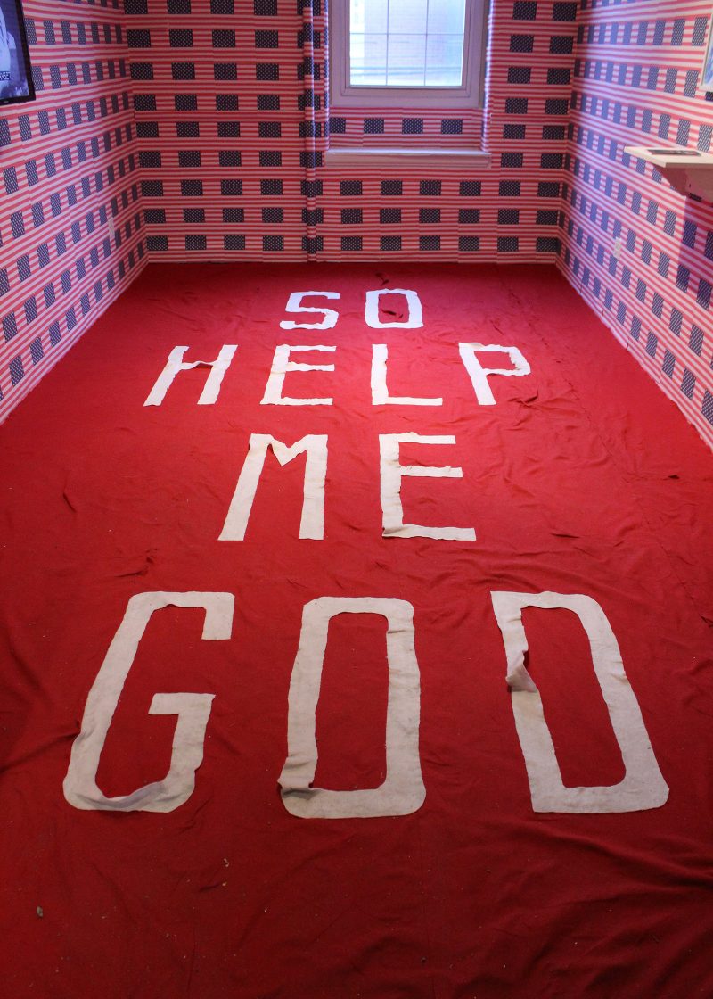 Letters on the floor of 'So Help Me God.'