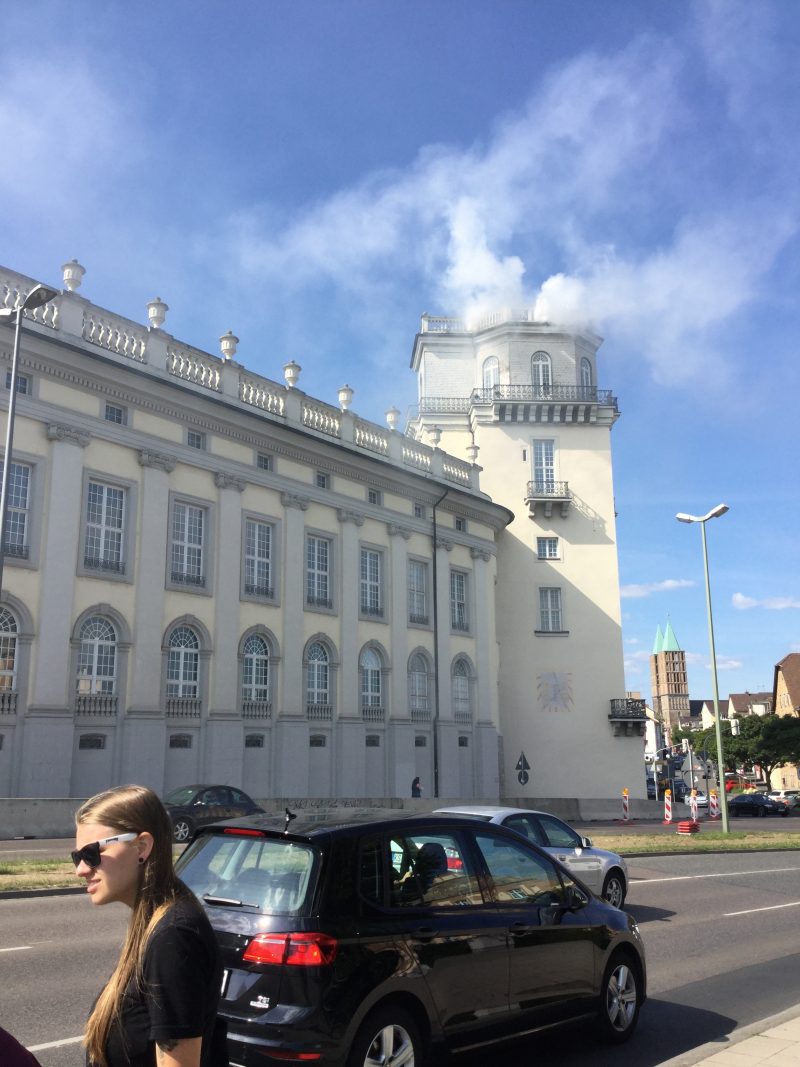 Daniel Knorr (b. Romania) Expiration Movement (2017)…white smoke signal coming out of Fridericianum tower/chimney during open hours of the exhibit. The smoke has numerous references, including an evocation of the Nazi crematoria as well as the burning of books