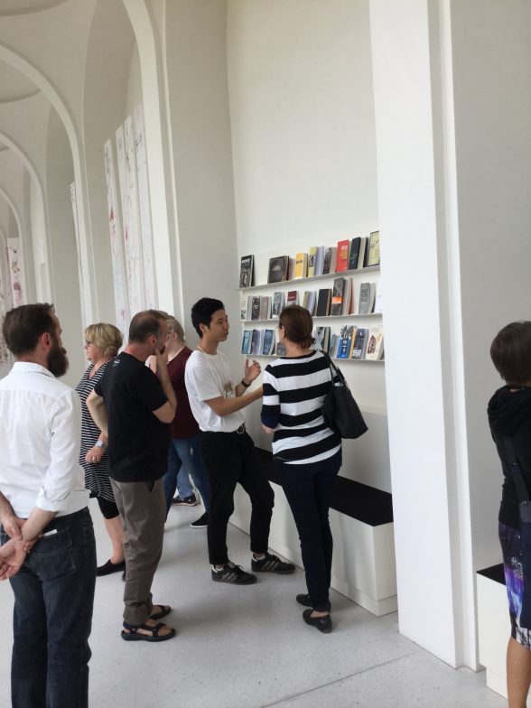 Chorus member, Park Gun Woo and our group looking at and talking about Maria Eichhorn’s Library and Reading Room, Rose Valland Institute, 2017, Neue Galerie, Documenta 14