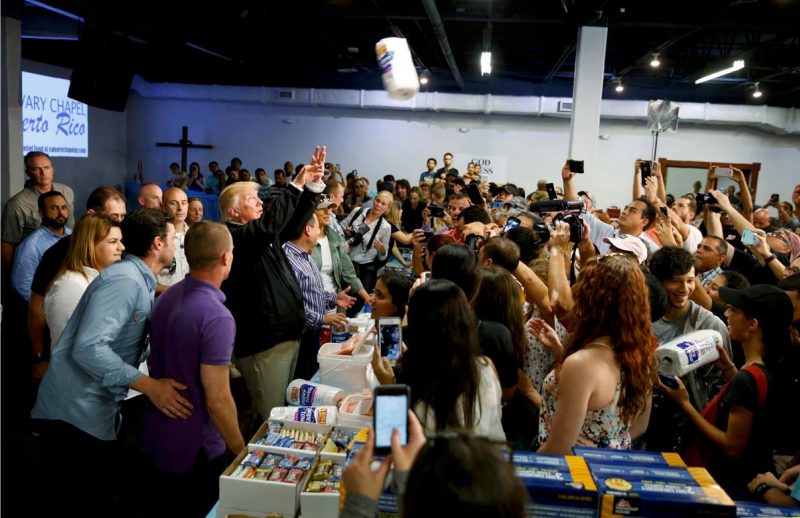 President Donald Trump throws rolls of paper towels into a crowd of local residents affected by Hurricane Maria as he visits Calvary Chapel in San Juan, Puerto Rico on Oct. 3, 2017. Jonathan Ernst / Reuters.