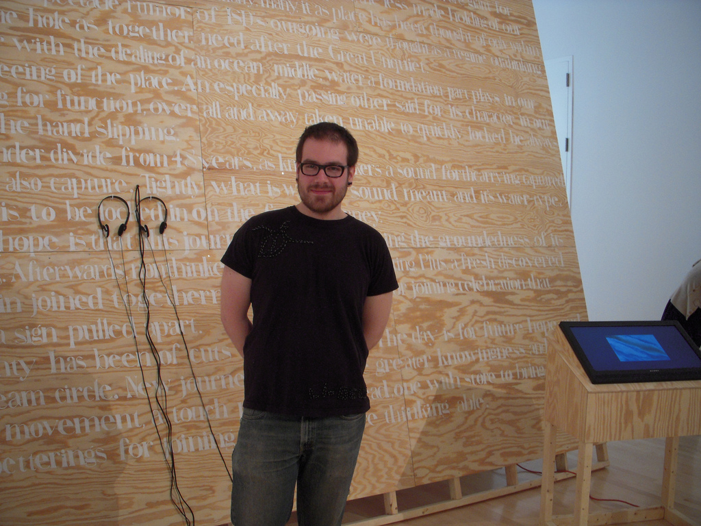 Mike Trefehn in front of his word wall in his history museum-ish installation.
