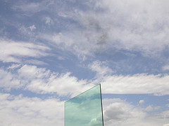 Cai Guo-Qiang's Clear Sky Black Cloud appearing at noon yesterday above the rooftop at the Metropolitan Museum of Art in New York. Click picture to see it bigger. The cloud --almost gone at this point -- is above the sheet of glass.