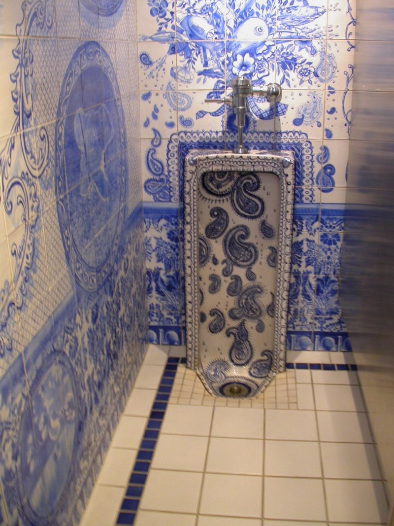 Detail, blue Delft-like Sheboygan mens room by Ann Agee with imagery from the city emblazoned on the walll.