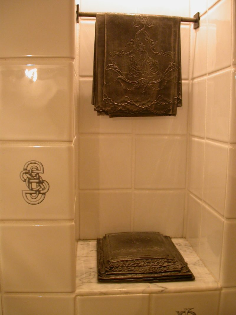 Merrill Mason's Emptying and Filling in one of the womens' bathrooms. Cast iron towels and toiletry objects set into little alcoves and accompanied by tiles with what appear to be monogram motifs. This installation, while nice, had a dark, Victorian affect that reinforced the woman's role as someone who tidies, primps and hostesses parties.