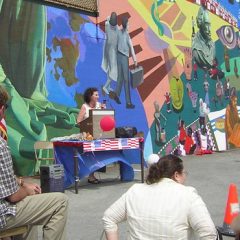 That's Deborah Zuchman behind the podium speaking, in front of a mural created in 2005 by Eliseo Silva and the students at Spruance Elementary School in Northeast Philadelphia.
