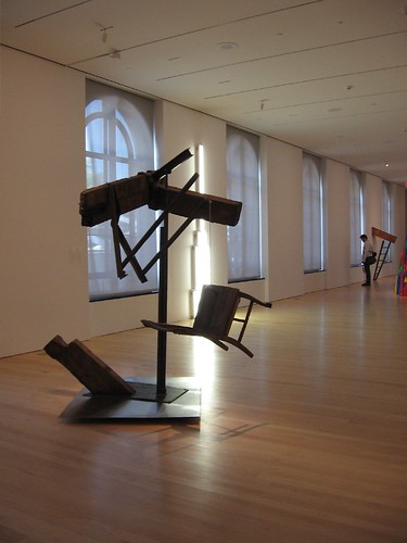 Mark di Suvero's Amerigo for My Father, 1963, silhouetted against the windows of the sculpture space.