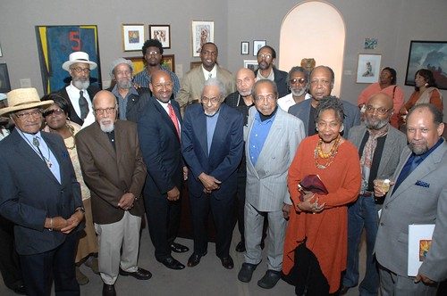 That's Mayor Michael Nutter (in the red tie) along with local artists whose work is in the exhibition Missing Masters: The Lewis Tanner Moore Collection of African American Art at the Woodmere Art Museum. Left to right in the front: Louis Sloan, Paul Keene, Nutter, Edward Loper, James Camp, Barbara Bullock and Curlee Holton (holding the book). In the back (left to right): (woman: unidentified visitor), Richard Watson, James Atkins, Sterling Shaw, Berrisford Boothe, Charles Burwell, Ulysses Marshall, Don Camp, and Ed Hughes. 