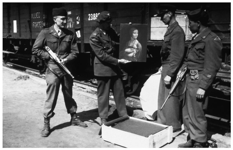 Polish art historian Karol Estreicher with MFAA officer Lt. Frank P. Albright and two American GIs as they prepare to return Leonardo da Vinci’s Lady with an Ermine to the Czartoryski Museum in Cracow, Poland, from which it had been stolen by the Nazis. Photo Source: Lynn Nicholas