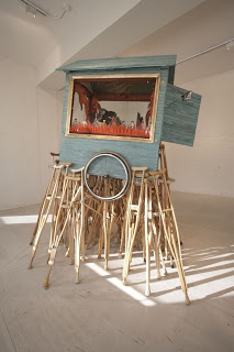 Pepón Osorio Lonely Soul (2008), Approx. 106 ½ x 83 x 77 inches, wooden crutches, fiberglass, Styrofoam, wood, resin, photographs, metals, human hair, one-thousand pins, hair clips, and wheelchair wheels, courtesy Ronald Feldman Fine Arts, New York, photo: Matthew Septimus. Courtesy P.S.1 Contemporary Art Center