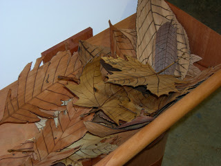 Detail of Lee Stoetzel’s leaves, each made from the corresponding wood of its species.