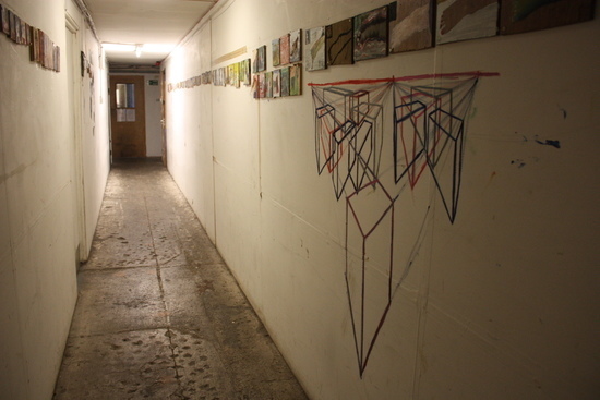 Paintings installed in a warehouse corridor