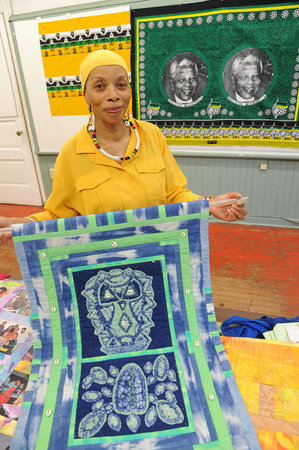 Betty Leacraft with her latest quilt, an honor to Nelson Mandela's work. Photo: Leeway Foundation.