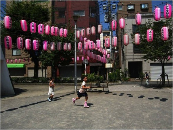 Hanging decorations overtop street with children