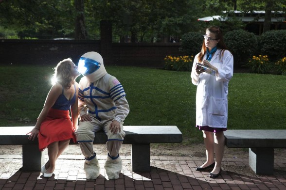 Photograph of a woman kissing an astronaut