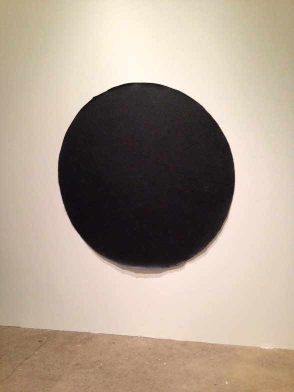 big black round painting on a wall