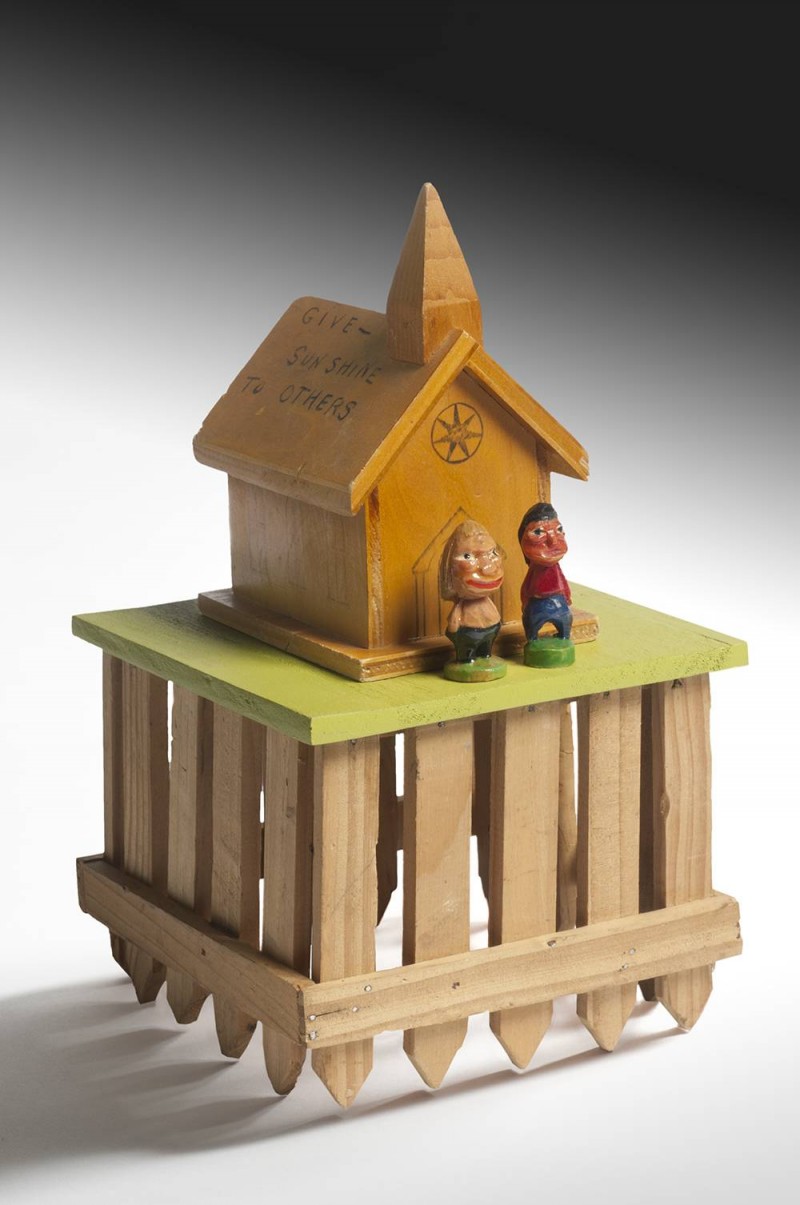 sculpture of house on top of crate