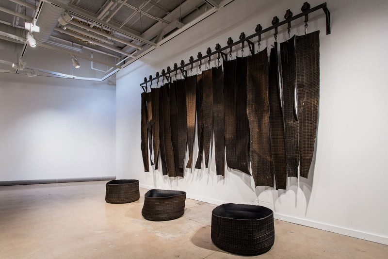 Epilogue in Black, 2015, race car tires, meat hooks, steel, used-engine parts, spray foam, enamel paint (dimensions variable). Image by Sarah Bloom 