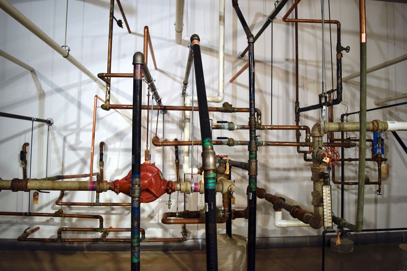 Stage Engine, 2015, birdcage, race car tank, fire sprinkler, steel, PVC, copper, cement, tape, hanging fixtures, spray foam, gold paint (dimensions variable). Image by Sarah Bloom 