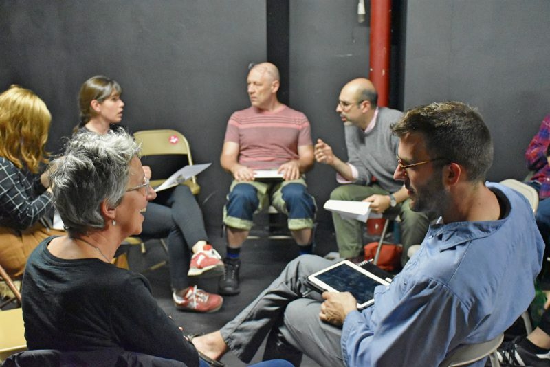 Audience members and panelists chit chatting before the Art Crit discussion begins.