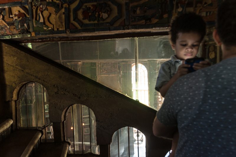 Fonthill, hallway outside the Salon. Tiny member of our tour group looks at something other than Fonthill. Photo by Chuck Patch, with permission under CC