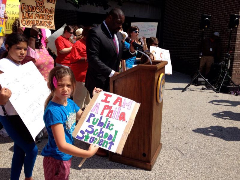 Lucy with a poster for Philadelphia public school funding rally