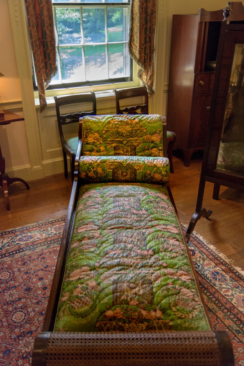 Slip-covered divan, re-upholstered with antique fabric originally made for some other purpose
