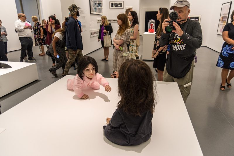 Playdate, 2006, A baby Michael Jackson crawls toward a baby Charles Manson. Media Preview, Indecent Exposure, Baltimore Museum of Art. Photo by Chuck Patch, with permission