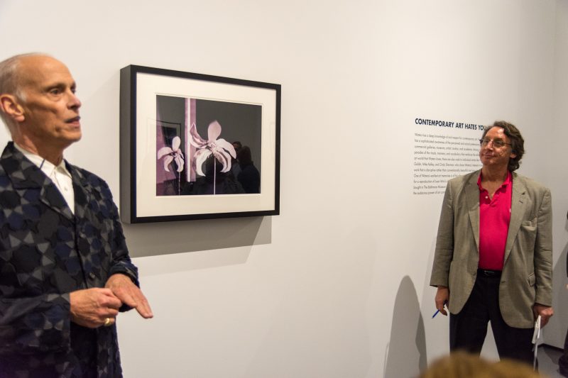 John Waters with the piece "Hardy Har" Media Preview, Indecent Exposure, Baltimore Museum of Art. Photo by Chuck Patch, with permission