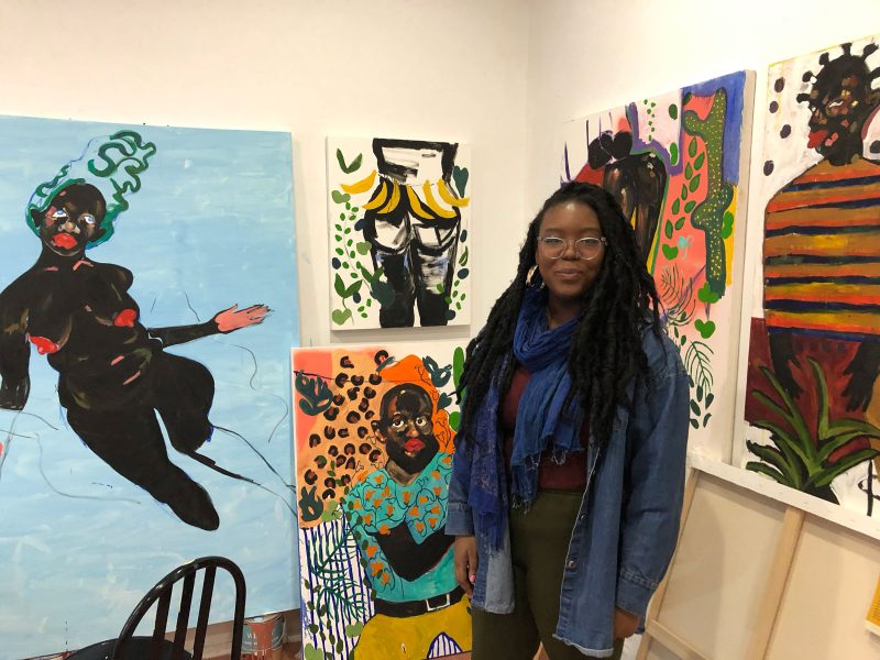 Patricia Thomas with her paintings in her 40th Street Artist in Residence studio. Photo courtesy of Morgan Nitz