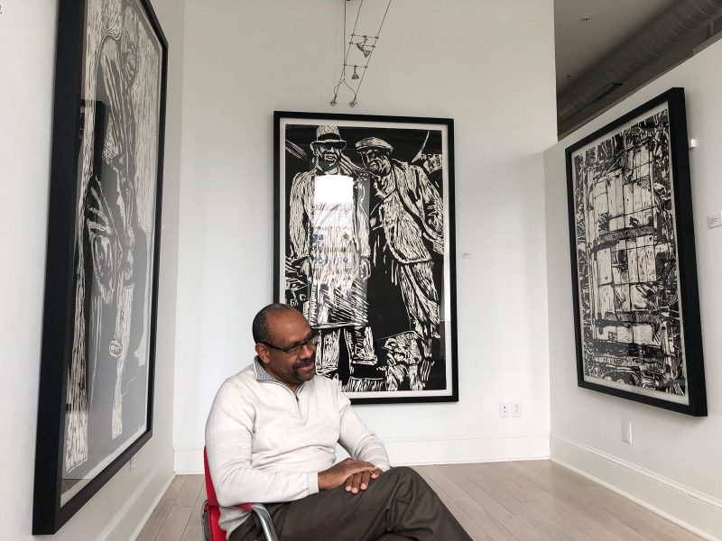 Allan Edmunds, President of Brandywine Workshop and Archives, with work from "Culture Quilt" by John T Scott at The Printed Image gallery.