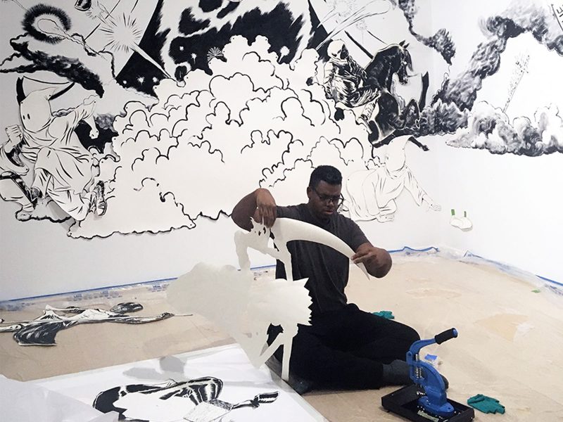 Mark Thomas Gibson at work installing "The Dangerous One" at Rosenwald-Wolf Gallery. Photo courtesy of Kathryn Gegenheimer.