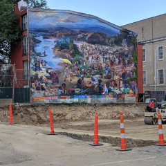 Ann Northrup's mural, One World, at Independence Charter School, showing excavation of new gym building that will cover the mural.