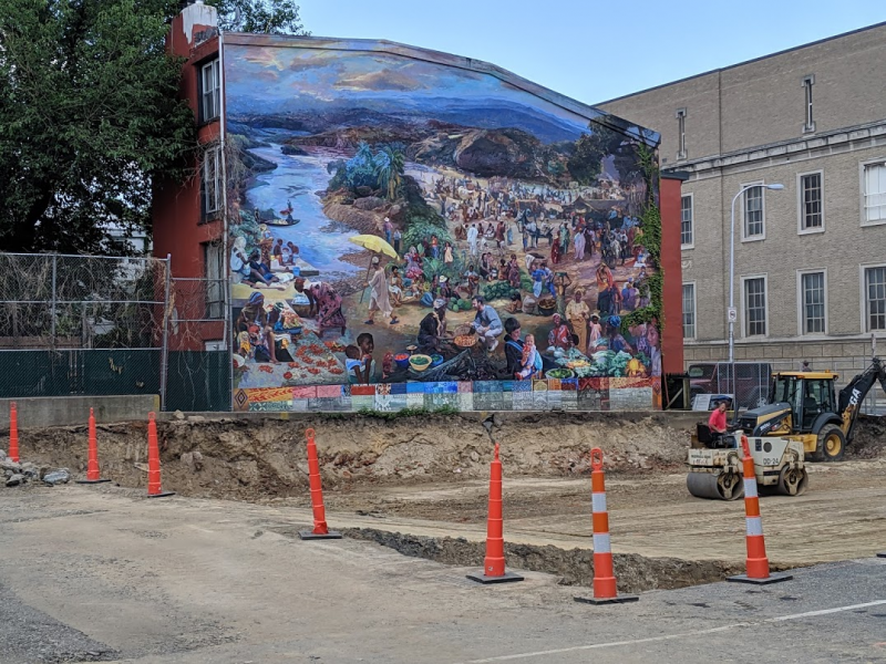 Ann Northrup's mural, One World, at Independence Charter School, showing excavation of new gym building that will cover the mural.