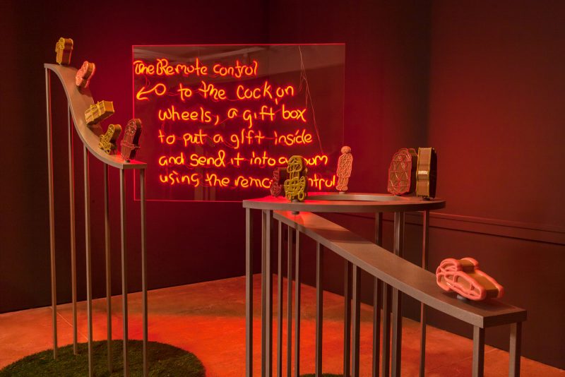 Jacolby Satterwhite, in collaboration with The Fabric Workshop and Museum, Philadelphia. The Remote Control for Cocks on Wheels, 2019. Powder-coated steel, plywood, artificial turf, magnets, PLA filament, epoxy, epoxy resin, enamel, baking soda, superglue, bond filler, plexiglass, LED, and silicone. Sculptures: 62 x 44 (diameter) inches, 78 x 44 (diameter) inches, 54 x 70 (diameter) inches, Neon: 48 x 59 inches. Photo credit: Carlos Avendaño.
