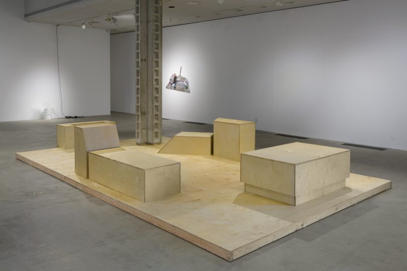 Installation view of Loitering is delightful, Los Angeles Municipal Art Gallery, October 31, 2019 - January 12, 2020. Image courtesy of the Los Angeles Municipal Art Gallery. Photograph by Jeff McLane. Works visible (Foreground to Background): Lauren Davis Fisher, “Untitled (Municipal Boxes),” 2019. Plywood. Dylan Mira, “NWOT C#,” 2019. Ultrasonic discs, buckets, fans, water, charcoal, herbal infusion made with Sun Song of poppy, plantain, gingko, mugwort, sinicuichi. Asha Schechter “Black Dustpan and petals and can and fur and shards and bolt,” 2019. Inkjet print on adhesive vinyl