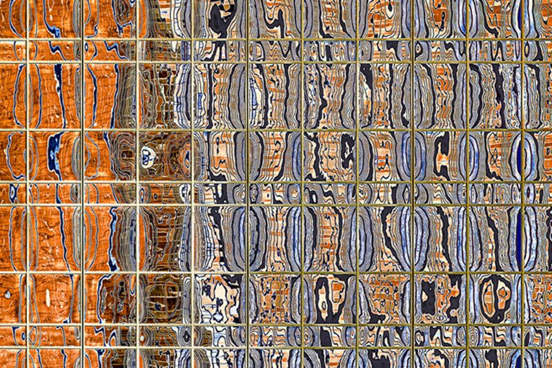 Many tiny panels of glass reflecting patterns of orange and blue