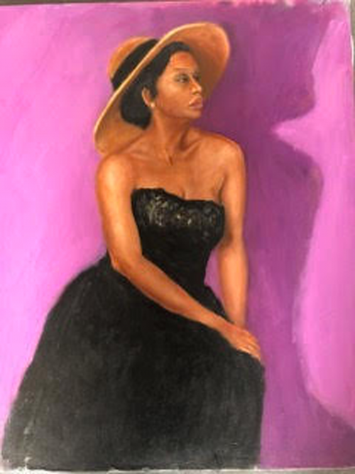 Figure portrait of a woman wearing a black dress and a wide brimmed hat in front of a pink wall.
