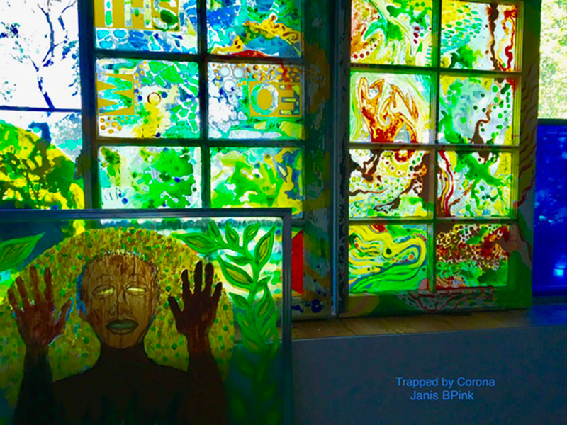 In the background, personalized stain glass style windows, in the front, a figure with their hands held by their hands painted on a window.