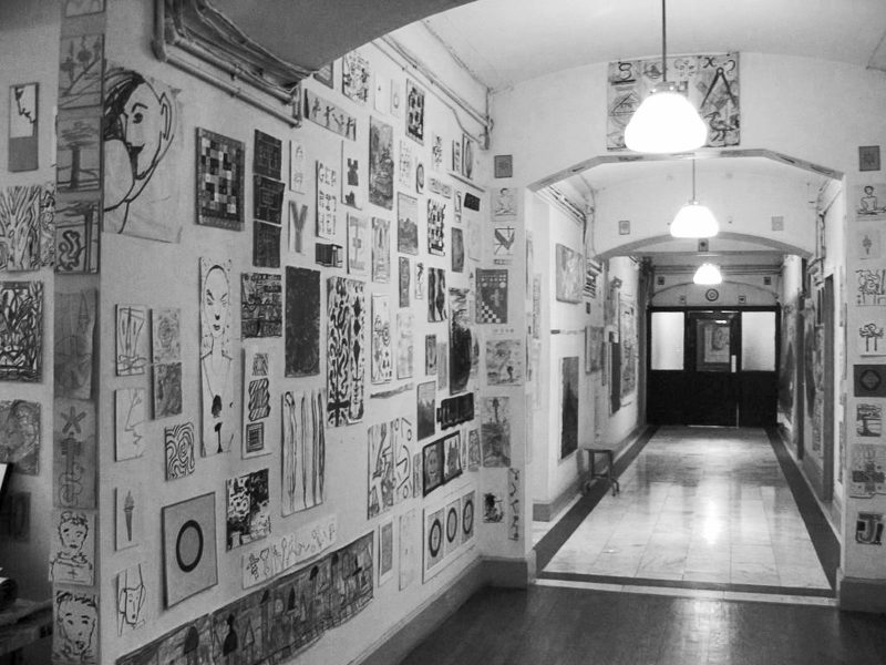 Long hallway with artwork all over the walls.