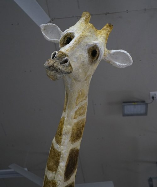 Close-up of the head of a sculpture of a giraffe.