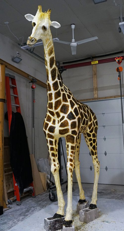 Full view of a sculpture of a giraffe.